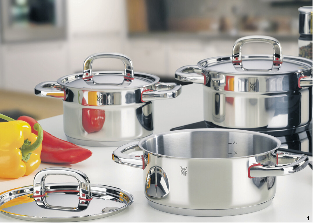 Hier werden die Metallgriffe nicht mehr hei�, weil ein roter Kunststoffring zwischen Topf und Griff eingesetzt ist.