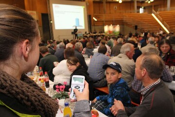 Mitgliederbefragung in der Arena Hohenlohe: Auf der Leinwand �ber der B�hne im Hintergrund erscheint die Frage. Die Mitglieder antworten per Klicker und Zahlencode. Sibille Gaugler aus Ellwangen (links im Vordergrund) h�lt f�r den Fotografen einen Klicker ins Bild.